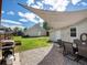 A backyard featuring a patio with shade and a lush lawn at 3134 W Center Ave, Denver, CO 80219