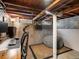 Cozy basement corner featuring a beanbag chair, rug, and built-in shelving at 3134 W Center Ave, Denver, CO 80219