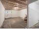 Large unfinished basement with white walls, concrete floors, and endless possibilities for customization at 3134 W Center Ave, Denver, CO 80219