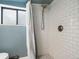 Shower featuring white subway tile, a showerhead with a hose, and a window for natural light at 3134 W Center Ave, Denver, CO 80219