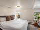 Bright primary bedroom featuring a queen size bed, two windows, and neutral wall color at 3134 W Center Ave, Denver, CO 80219