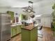 Bright kitchen with wood island, stainless steel appliances and lots of storage at 3134 W Center Ave, Denver, CO 80219