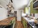 Kitchen featuring wood island and stainless steel appliances at 3134 W Center Ave, Denver, CO 80219