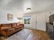 Bright living room with hardwood floors and large window showing a fenced yard at 3134 W Center Ave, Denver, CO 80219