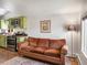 Living room with view of the kitchen, featuring a comfortable brown couch at 3134 W Center Ave, Denver, CO 80219