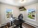 Bright office space with two windows featuring a standing desk and black computer chair at 3134 W Center Ave, Denver, CO 80219