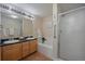 Bright bathroom features dual sinks, tub, and separate glass-enclosed shower at 6004 W Colorado Ln, Lakewood, CO 80232