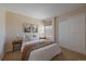 Cozy bedroom with a queen bed, closet, and natural light from the window at 6004 W Colorado Ln, Lakewood, CO 80232