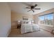 Bright bedroom with a ceiling fan and a large window letting in natural light at 6004 W Colorado Ln, Lakewood, CO 80232