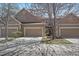 Inviting townhome featuring a two-car garage and well-maintained landscaping at 6004 W Colorado Ln, Lakewood, CO 80232