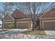 Inviting townhome featuring a two-car garage and well-maintained landscaping at 6004 W Colorado Ln, Lakewood, CO 80232