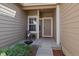 Charming front porch featuring a cozy chair and meticulous landscaping at 6004 W Colorado Ln, Lakewood, CO 80232