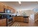 Bright kitchen with stainless steel appliances, granite countertops, and wood cabinets at 6004 W Colorado Ln, Lakewood, CO 80232