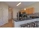 The kitchen has black countertops with a stainless steel sink and seating at the breakfast bar at 6004 W Colorado Ln, Lakewood, CO 80232