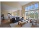 Bright living room with a view to the dining room and soaring ceilings at 6004 W Colorado Ln, Lakewood, CO 80232