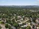 Aerial view of a neighborhood with lush green trees and single-Gathering homes at 10400 W 35Th Pl, Wheat Ridge, CO 80033