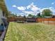 Spacious backyard with lush lawn, garden beds, trampoline, and privacy fence at 10400 W 35Th Pl, Wheat Ridge, CO 80033
