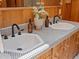 Bathroom with double sinks, black faucets, decorative tile, and stylish vanity at 10400 W 35Th Pl, Wheat Ridge, CO 80033