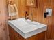 Modern bathroom sink with wood paneling, stylish fixtures, and a simple design at 10400 W 35Th Pl, Wheat Ridge, CO 80033