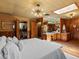 Bright bedroom with unique lighting, wood paneling, closet, and built-in vanity at 10400 W 35Th Pl, Wheat Ridge, CO 80033
