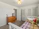 Bright bedroom featuring a wood dresser, decorative pillows, and a cozy, patterned blanket at 10400 W 35Th Pl, Wheat Ridge, CO 80033