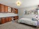 Bedroom featuring built-in wooden cabinetry and a cozy bed, illuminated by natural light from the window at 10400 W 35Th Pl, Wheat Ridge, CO 80033
