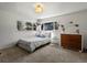 Bright bedroom with a twin bed and plush decor, next to a wooden dresser and sunlit windows at 10400 W 35Th Pl, Wheat Ridge, CO 80033