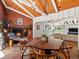 Inviting dining room boasts a brick fireplace, wood accents, and a unique octagon-shaped table for memorable gatherings at 10400 W 35Th Pl, Wheat Ridge, CO 80033
