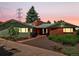 Charming single-story home featuring a brick facade, mature trees, and well-maintained landscaping at 10400 W 35Th Pl, Wheat Ridge, CO 80033