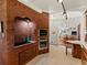 Kitchen with brick accent wall, oven, and a stove, adjacent to a dining area with an open layout at 10400 W 35Th Pl, Wheat Ridge, CO 80033