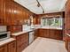 Traditional kitchen featuring rich wood cabinetry, white countertops, and modern appliances with a bright window at 10400 W 35Th Pl, Wheat Ridge, CO 80033