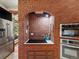 Kitchen with a brick stove, modern oven, and stainless steel refrigerator, offering a blend of style and functionality at 10400 W 35Th Pl, Wheat Ridge, CO 80033