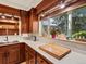 Kitchen featuring wood cabinets, white countertops, and a window offering natural light and greenery view at 10400 W 35Th Pl, Wheat Ridge, CO 80033