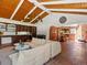 Open-concept living space with vaulted ceilings, stone floors, and seamless flow to the dining area and kitchen at 10400 W 35Th Pl, Wheat Ridge, CO 80033