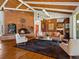 Open concept living room with brick fireplace, vaulted ceilings and hardwood floors at 10400 W 35Th Pl, Wheat Ridge, CO 80033