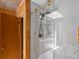 Contemporary shower featuring sliding glass doors and sleek design elements creating a luxurious showering experience at 10400 W 35Th Pl, Wheat Ridge, CO 80033