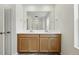Bathroom featuring double sinks with a large vanity mirror and tile flooring at 2079 Generations Aly, Brighton, CO 80601