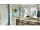 Stylish bathroom features a double vanity with modern fixtures and vibrant wall art at 2079 Generations Aly, Brighton, CO 80601