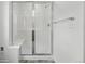 Bathroom featuring glass shower doors with a bench and tile walls at 2079 Generations Aly, Brighton, CO 80601