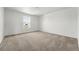 Spacious empty bedroom with neutral carpet and natural light from the window at 2079 Generations Aly, Brighton, CO 80601