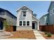 Charming two-story home with gray siding, stone accents, and a well-maintained front yard at 2079 Generations Aly, Brighton, CO 80601
