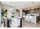 Eat-in kitchen boasts stainless appliances, a center island with seating, and modern pendant lighting at 2079 Generations Aly, Brighton, CO 80601