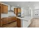 Modern kitchen with stainless steel appliances, wood cabinets and a large island at 2079 Generations Aly, Brighton, CO 80601