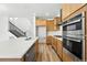Bright, open kitchen with stainless steel appliances, wood floors, and a large island at 2079 Generations Aly, Brighton, CO 80601