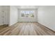Bright, spacious living area with wood floors and ample natural light from large windows at 2079 Generations Aly, Brighton, CO 80601