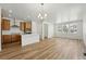 Bright, open-concept living space features wood floors, recessed lighting, and kitchen with a center island at 2079 Generations Aly, Brighton, CO 80601