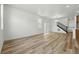 Expansive living area with wood floors, abundant natural light, and staircase at 2079 Generations Aly, Brighton, CO 80601