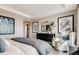 Serene primary bedroom showcases a tray ceiling, modern art, and a comfortable sitting area at 2079 Generations Aly, Brighton, CO 80601