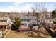 A full view of the house with a deck and some trees in the backyard at 3819 S Waco St, Aurora, CO 80013