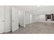 Finished basement with modern flooring, ample lighting, and multiple rooms at 3819 S Waco St, Aurora, CO 80013